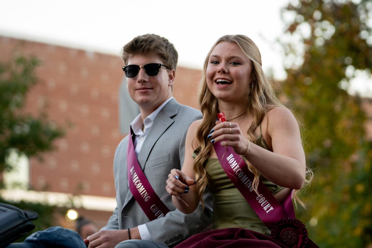 Madison Kissinger and Zach Mazer throwing out candy at State High’s homecoming parade. 