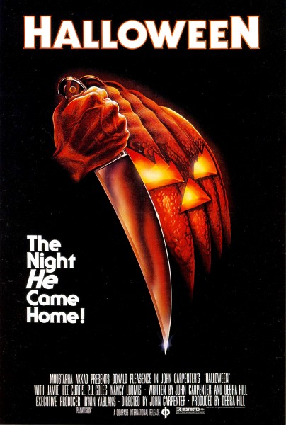 A scary looking pumpkin with sharp eyes and a triangular nose glows behind a hand holding a knife. Everything is orange. Text reads, "The night he came home!"