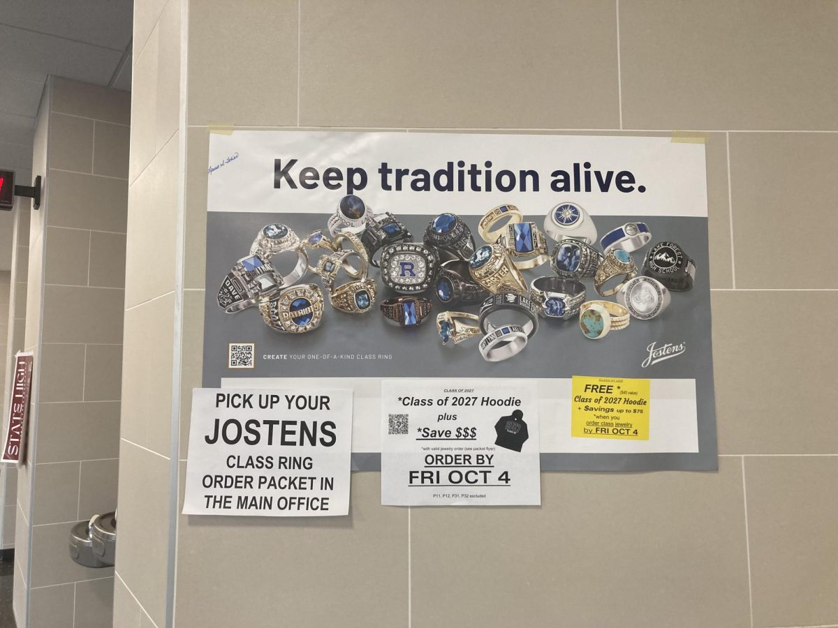 Jostens promotional poster hung outside of G2 hallway with pictures of fancy rings and text that reads "Keep Tradition Alive".