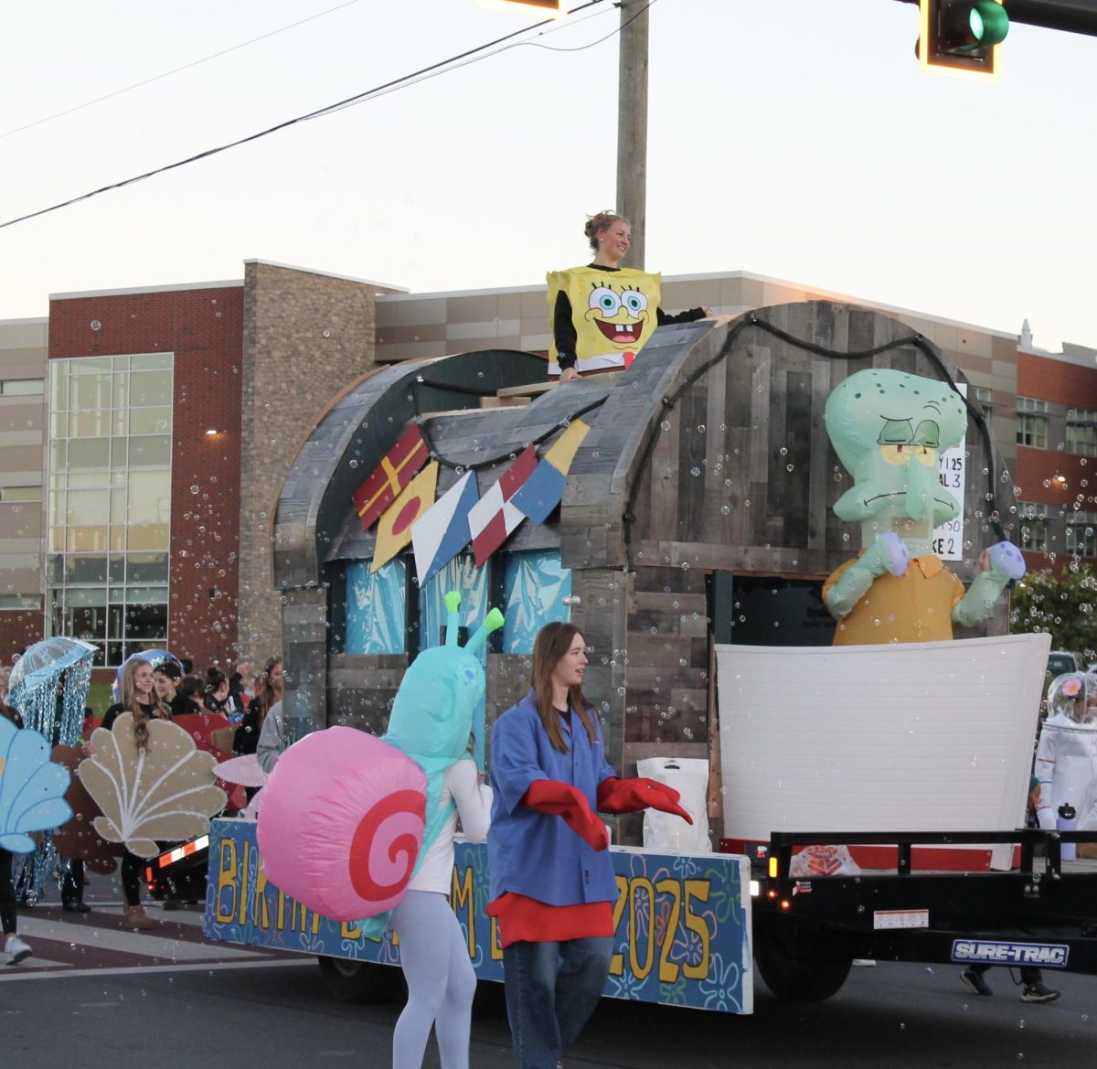 The Spongebob themed volleyball float parades by the front of the high school.