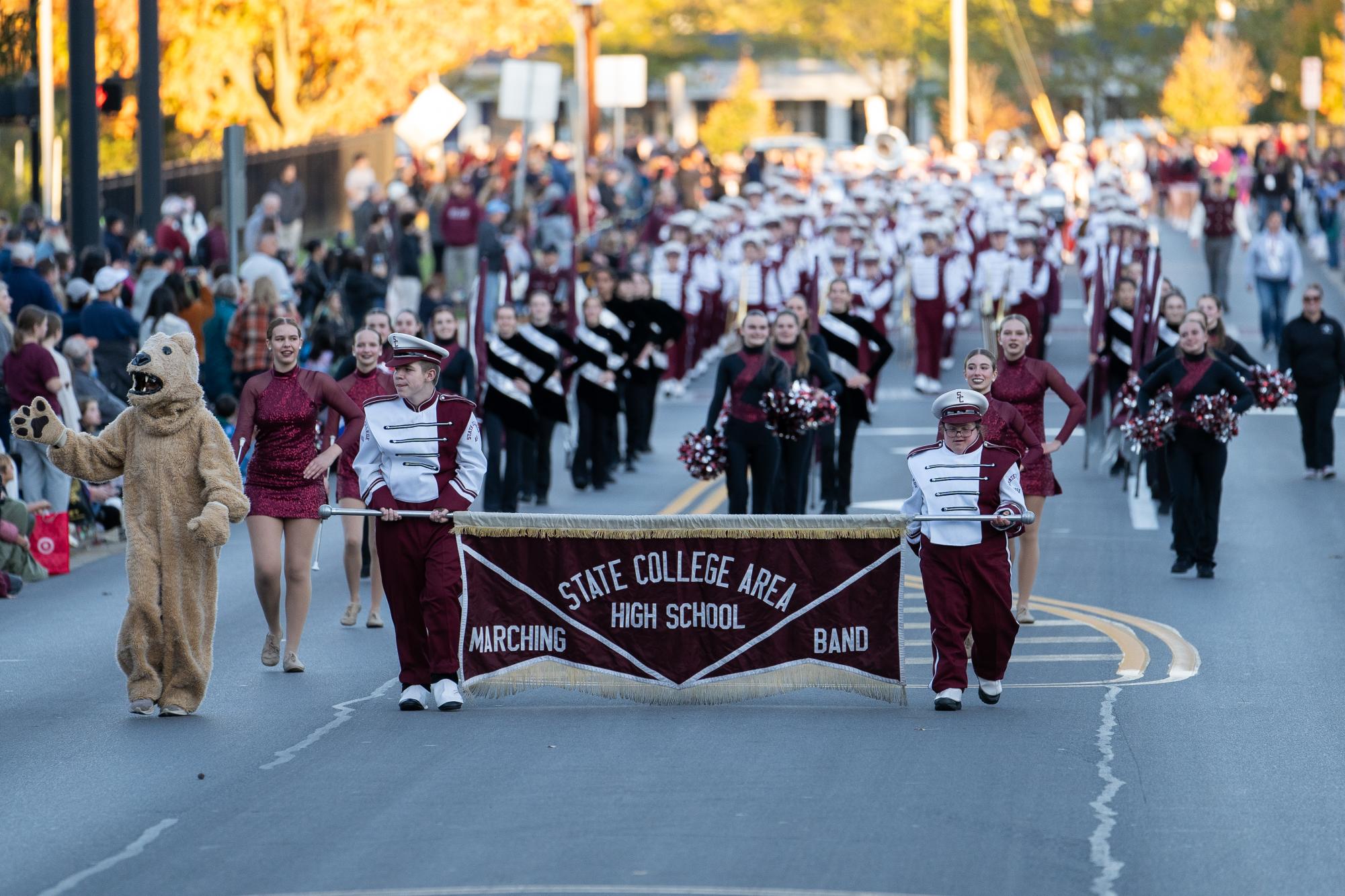 State High Marching Band walks towards the camera at the Homecoming Parade