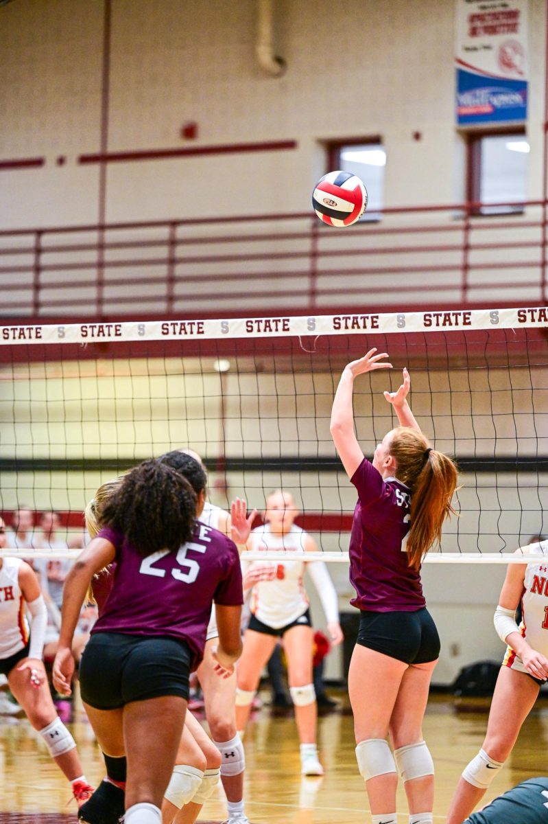 A SCAHS Girl's volleyball player sets a ball into the air.