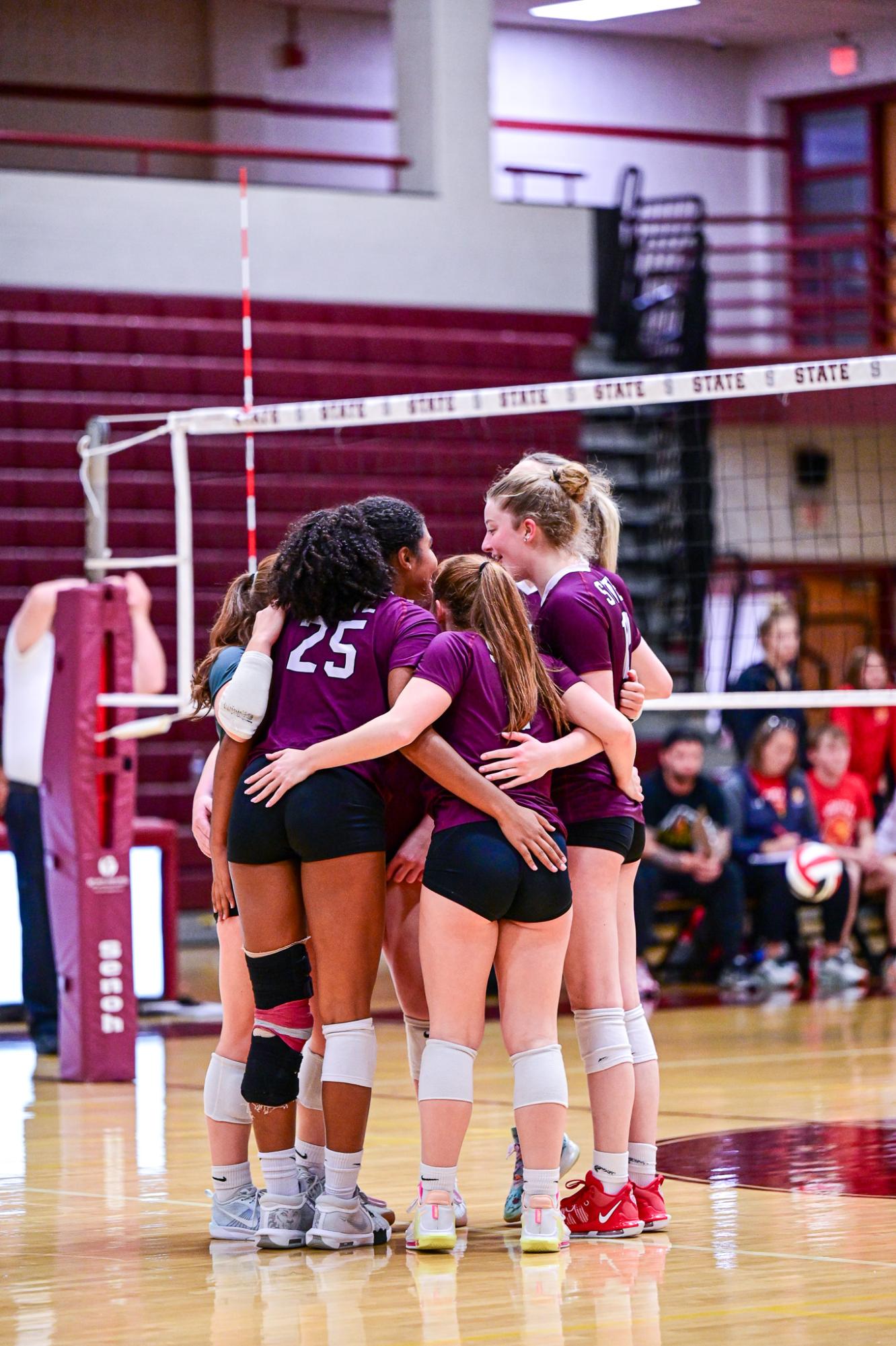 The State College Girl's Volleyball team congregates after a point, smiles on their faces. The chemistry of the team was vital to their success as a whole, with all the players supporting each other and buying in to each game. 