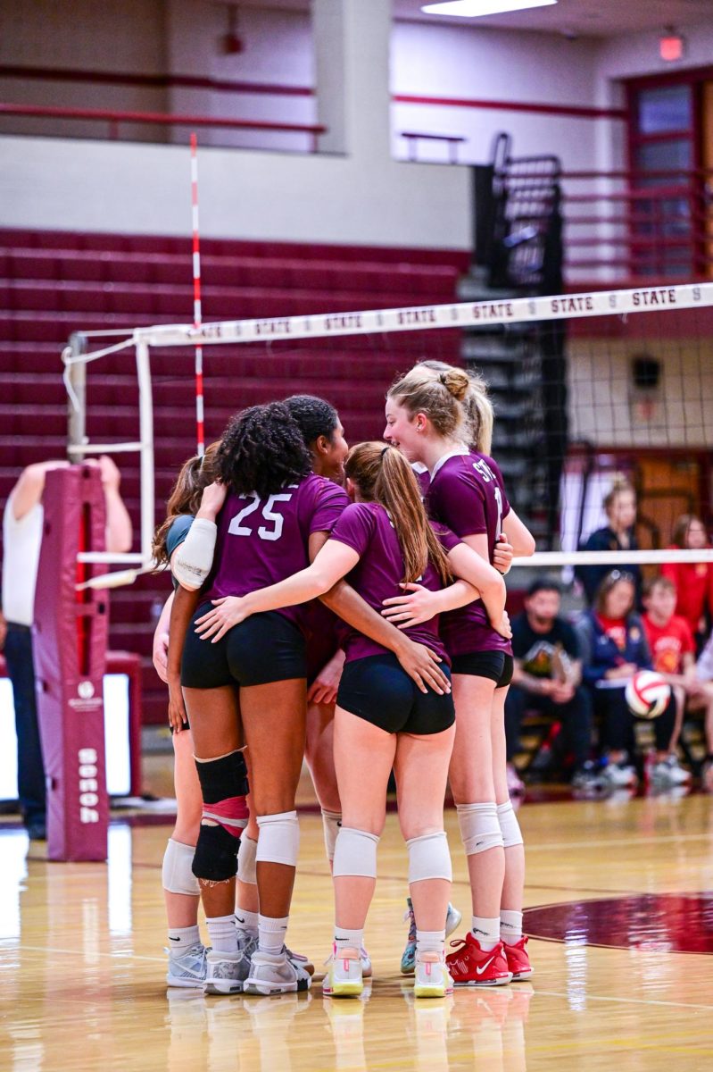 The SCAHS Girl's Volleyball team huddles up on the court.