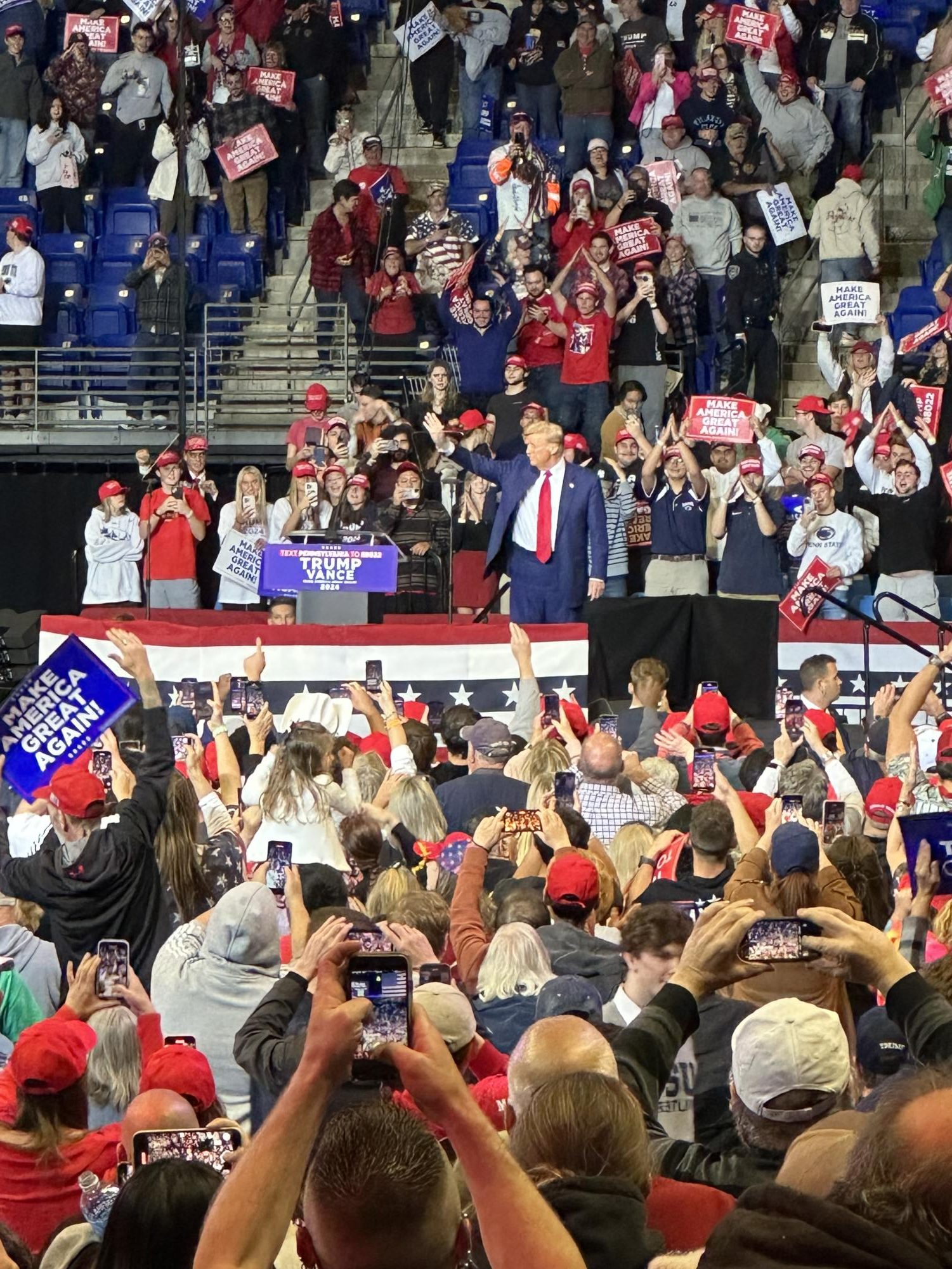 President-elect Donald Trump raises his hand at the start of his rally in State College, PA on Oct. 26. 