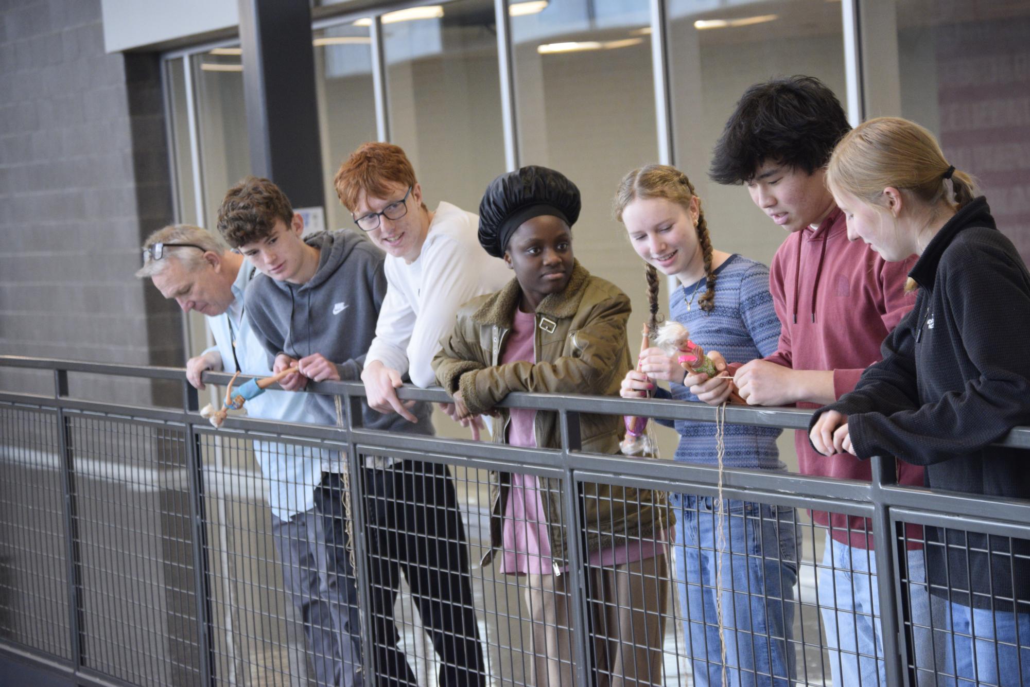 Students in IB Math Applications and Interpretations HL prepare to drop Barbie dolls with bungee cords for a project. 