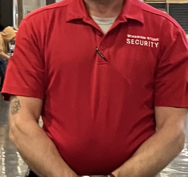 A security guard wears one of Standing Stone Security's signature red shirts. 