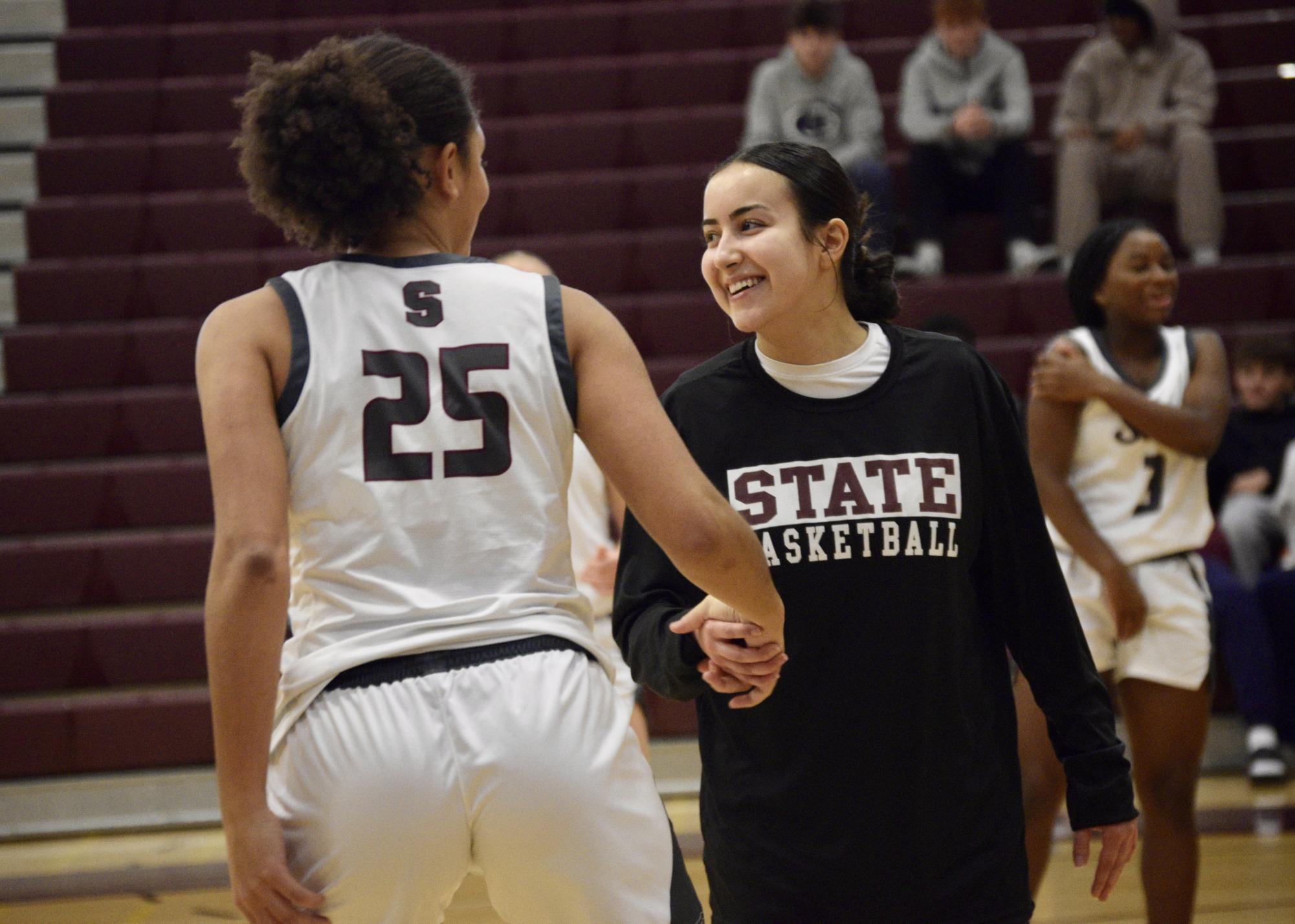 Senior Ceanna Irmak and junior Lydia Tate finish their handshake after the starting lineups were announced for the game against Norwin. 