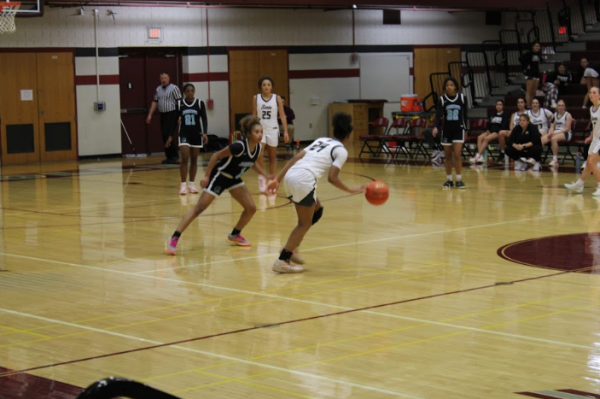 Sienna Wilson dribbling down the court.