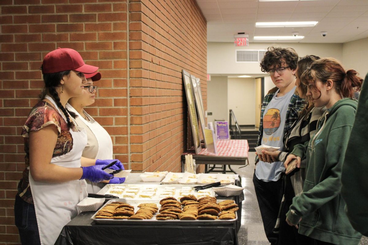 Culinary students working at the dessert table at the Empty Bowls event on Jan. 10 serve students and community members sweets made by State High Culinary students.