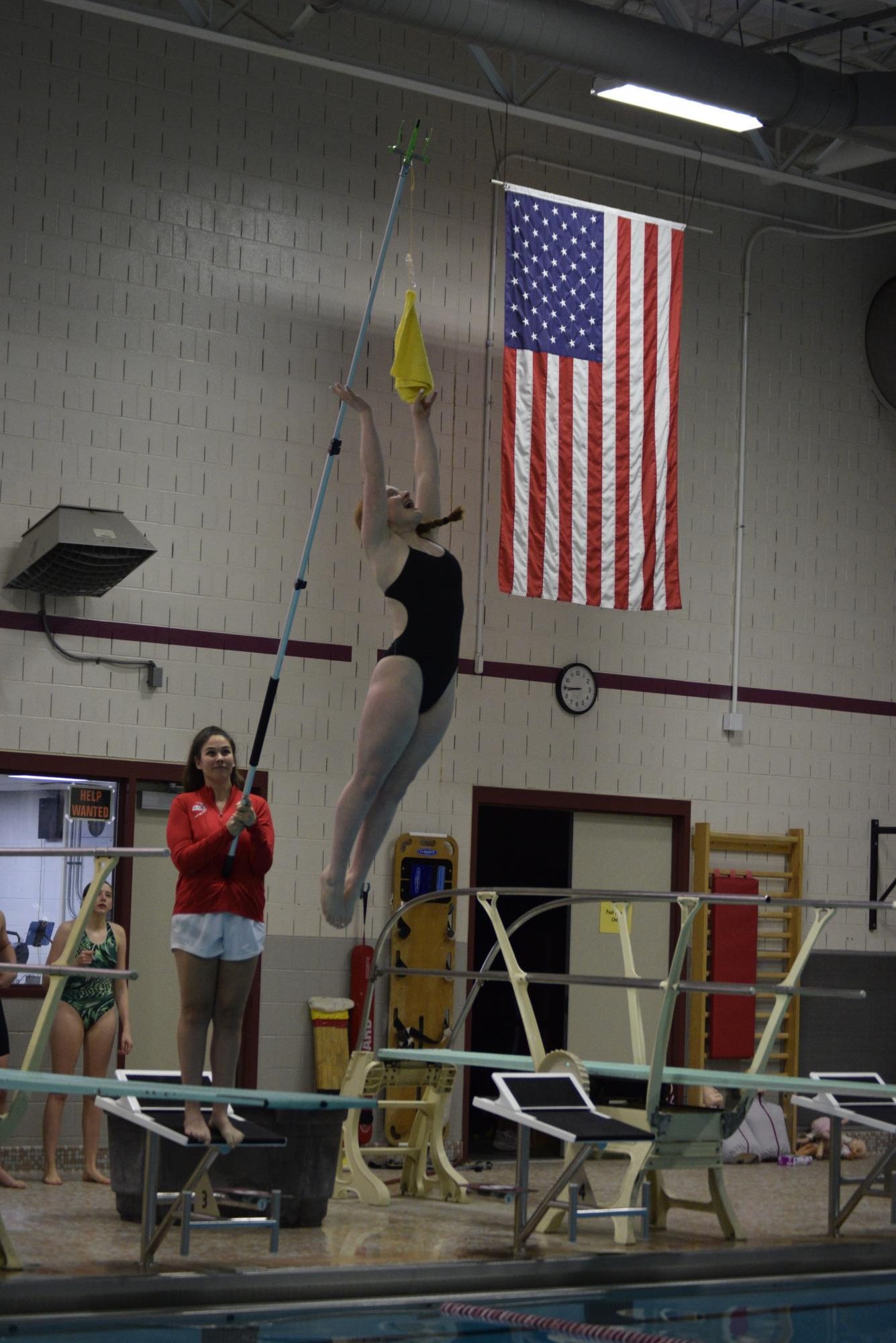 Caytlin Kramer, State High junior, works on her approach on the board, jumping to hit the yellow towel hanging above her. An important part of a successful dive is having a strong approach, to reach a good height for the skill you’re executing. Caytlin Kramer is a first year diver, coming in after various years in gymnastics, and has quickly picked up various skills, including somersaults, inward and reverse dives.