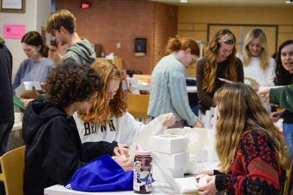 National Honors Society members prepare boxes to be packed with cookies for State High support staff on Dec. 16. 