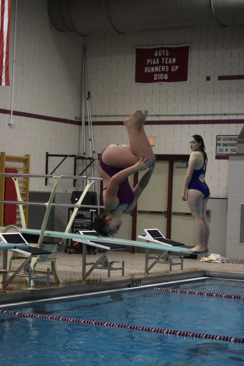 Cara Schuchert, freshman, practicing her back somersault in the tuck position on January 8th. As a first year diver, she is strongly progressing in her skills, and is motivated to get better.