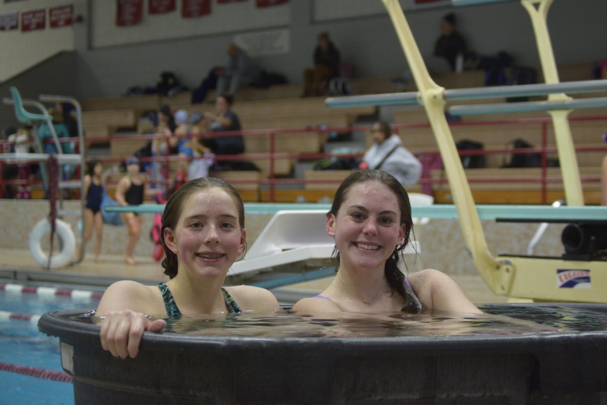 Freshman Nora (left) and Varrah Gramling (right), smiling for the camera while enjoying the team’s hot tub, at the end of practice on January 8th.