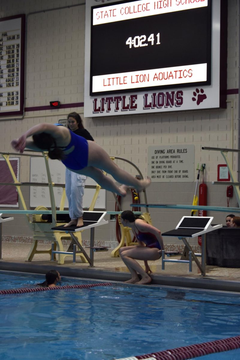 State High Junior, Julia Johaenning, practicing her back dives, during practice on January 10.