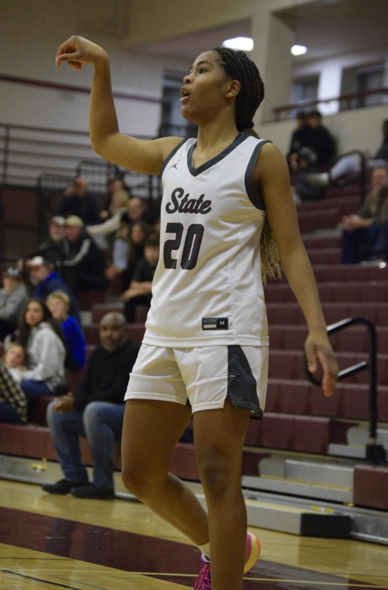 Sophomore Sheree Wilson holds her follow through after shooting a three-pointer against Linville Hill.