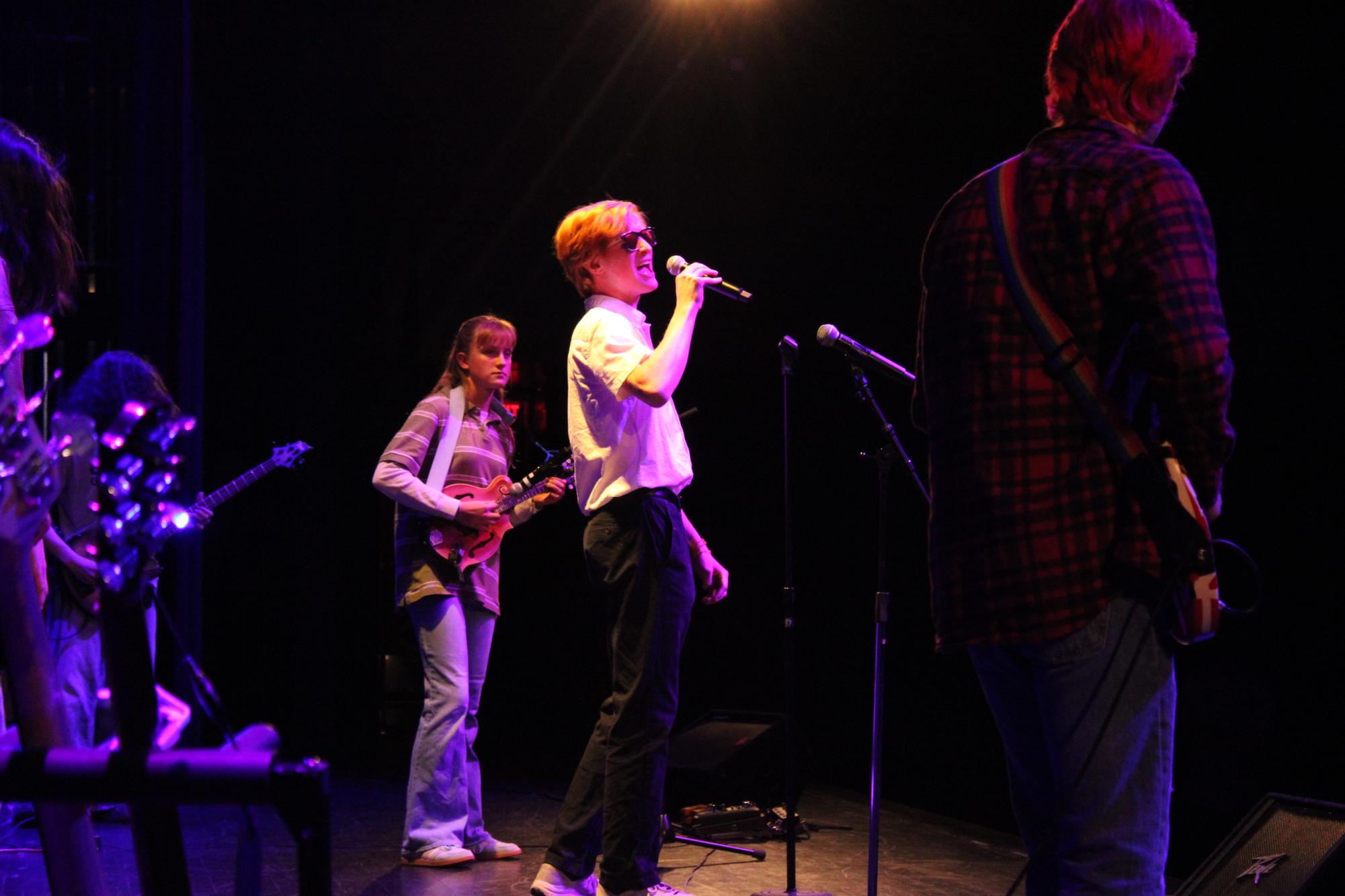 Junior Elliot Mathews sings “Learning to Fly” by Tom Petty. Mathews says his favorite song in the concert was "Change in the House of Flies" by Def Jams. He looked forward to the New York Song (“New York, I Love You" by LCD Soundsystem), commenting, “I don't know if everyone's going to like it, but I like it.”