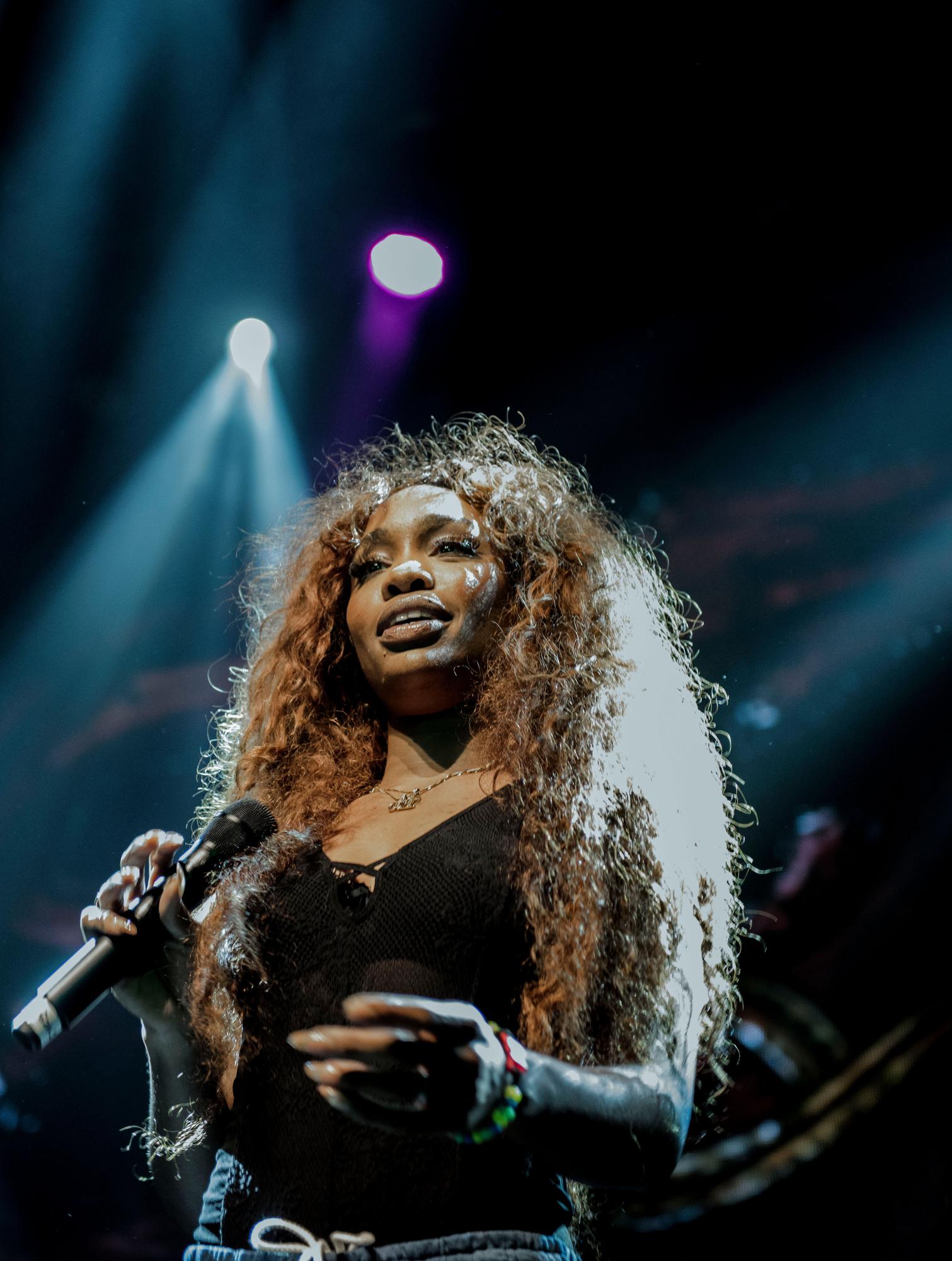 SZA performs at a concert in 2017. Photograph by Erin Cazes; The Come Up Show - https://www.flickr.com/photos/thecomeupshow/36611378912/, CC BY 2.0, https://commons.wikimedia.org/w/index.php?curid=62006995