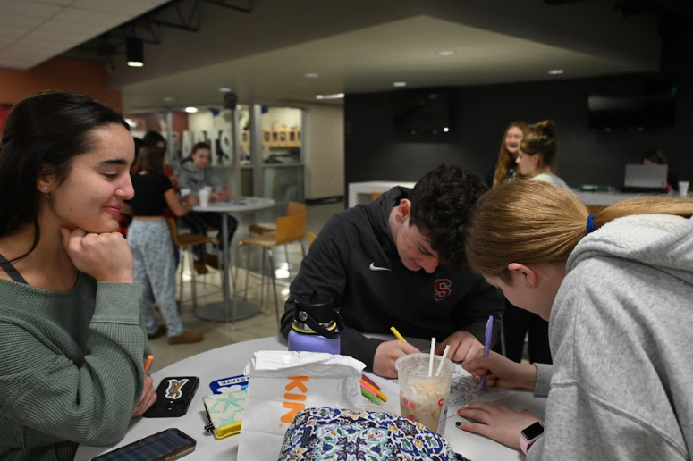 Students color together at a coloring station during the summit.