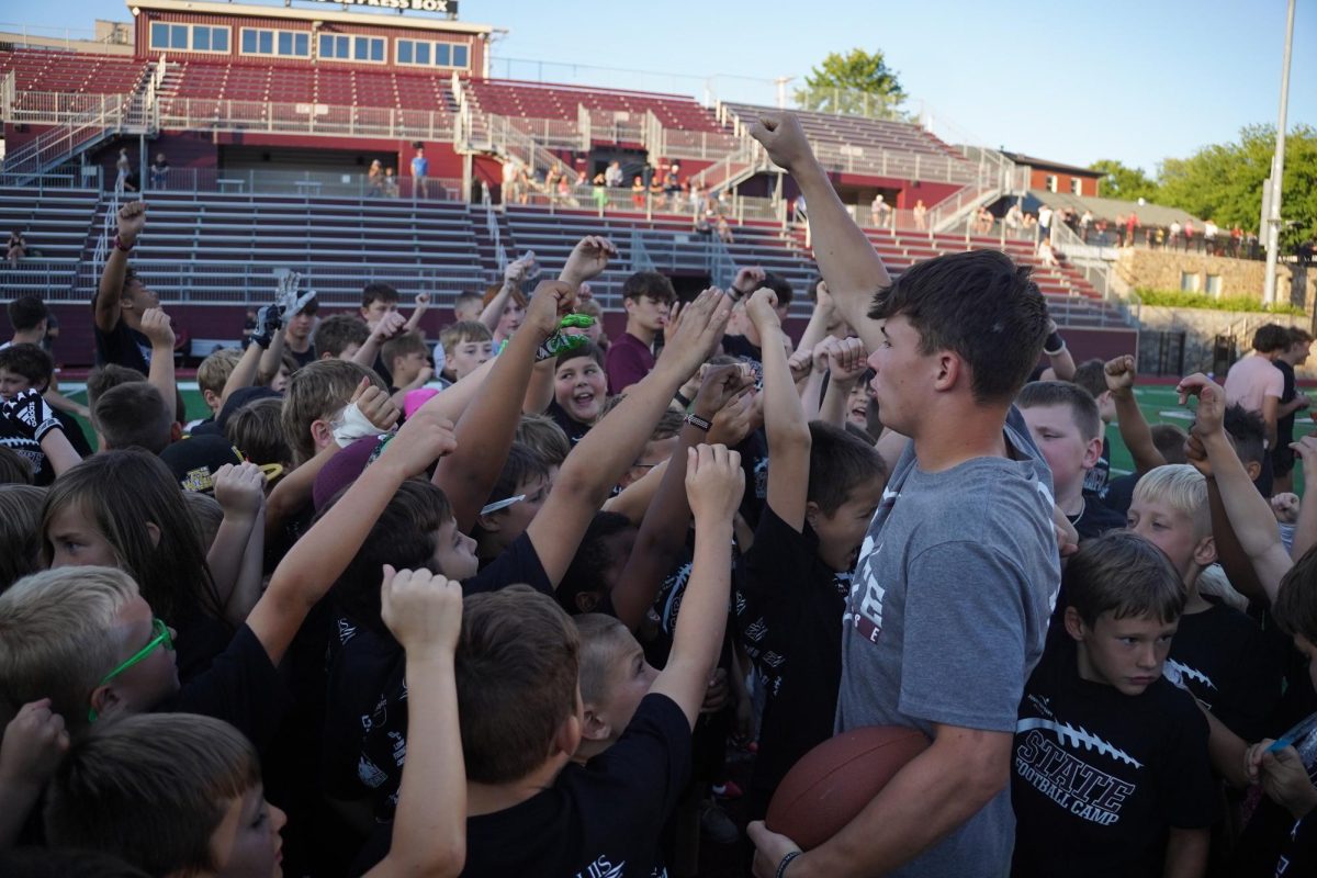 Senior Cooper Brushwood breaks down the huddle at the end of the State High Football Youth Camp in 2024.