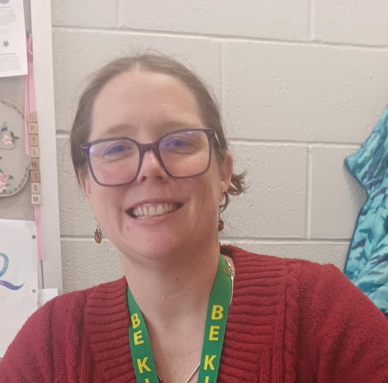 Delta High Program English teacher Kate Hoffman at her desk in the Delta building.  “Sort of insane to me that people pay me to talk about books,” Hoffman said. 