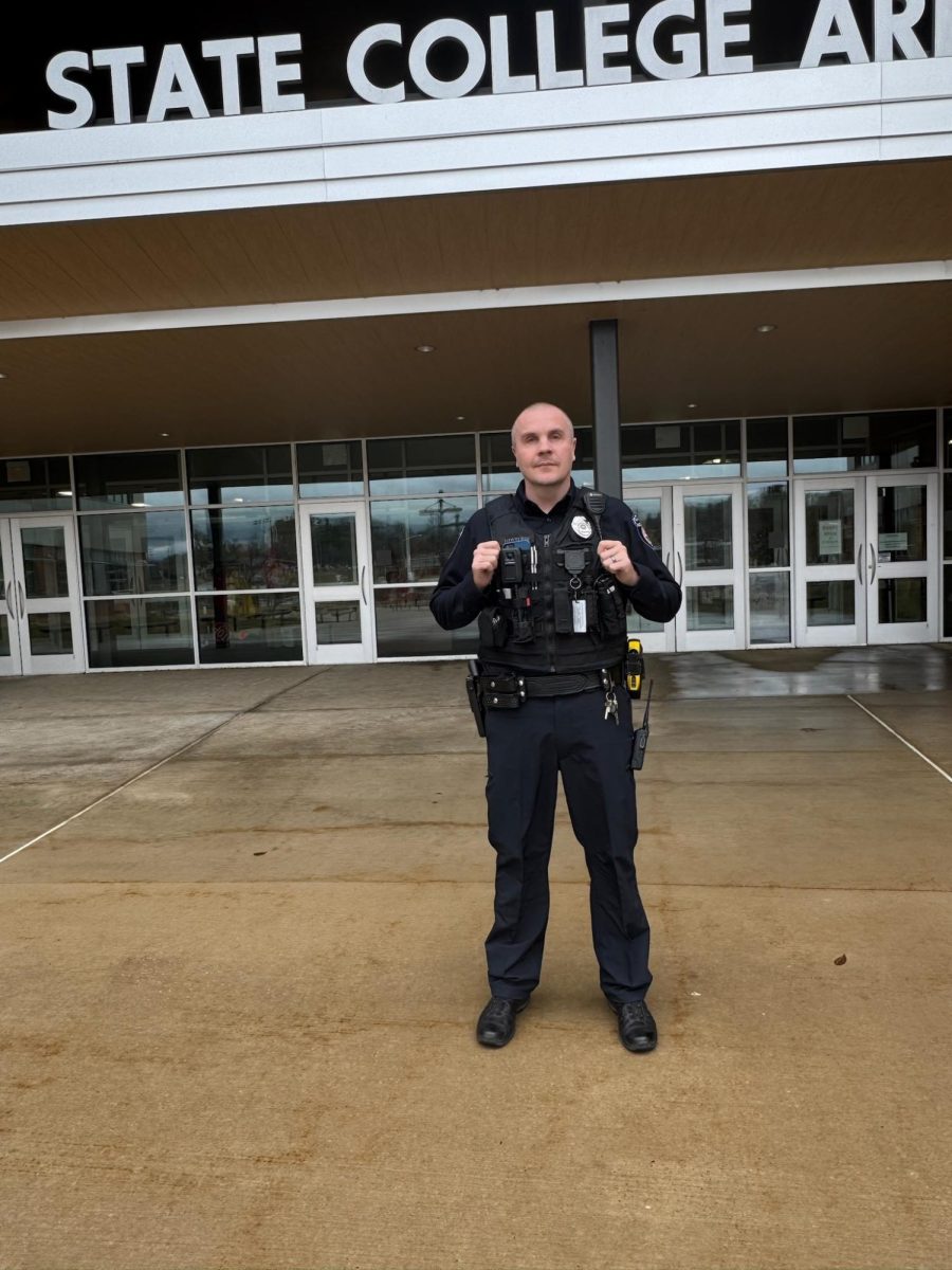 New School Resource Officer Matt Hertlein standing in front of State College Area High School.