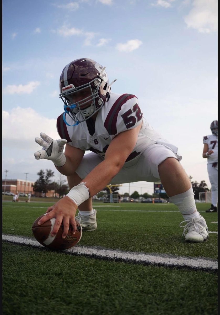 Senior Reese Wilson snapping the ball in warm-ups before a game.