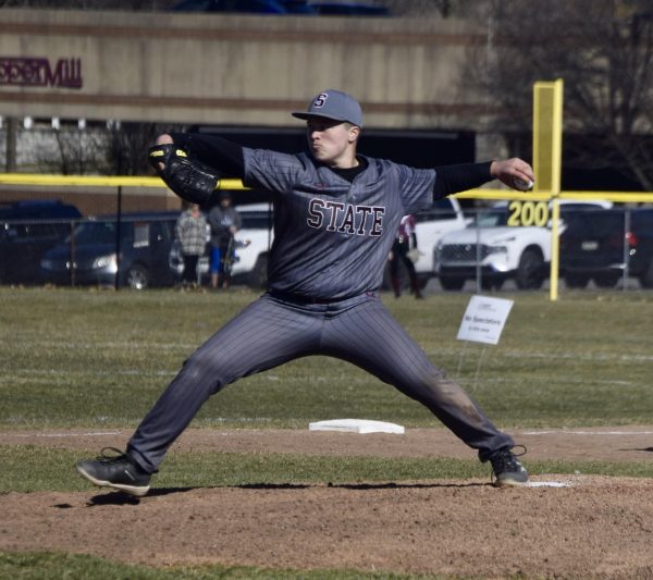 Senior Finn Powers strides forward to throw a pitch in the first inning.