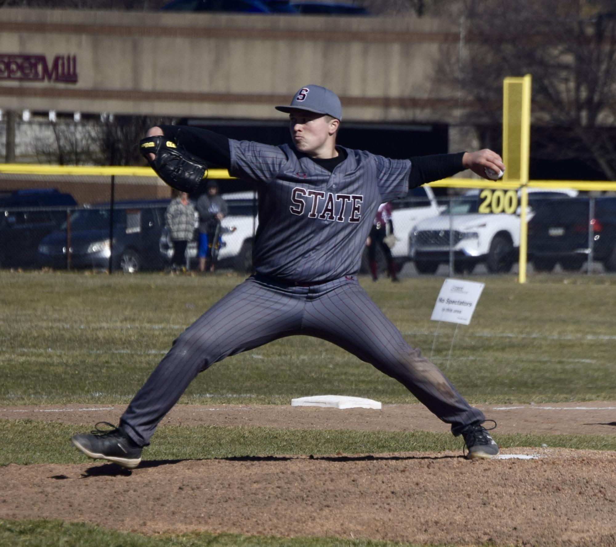 Senior Finn Powers strides forward to throw a pitch in the first inning.