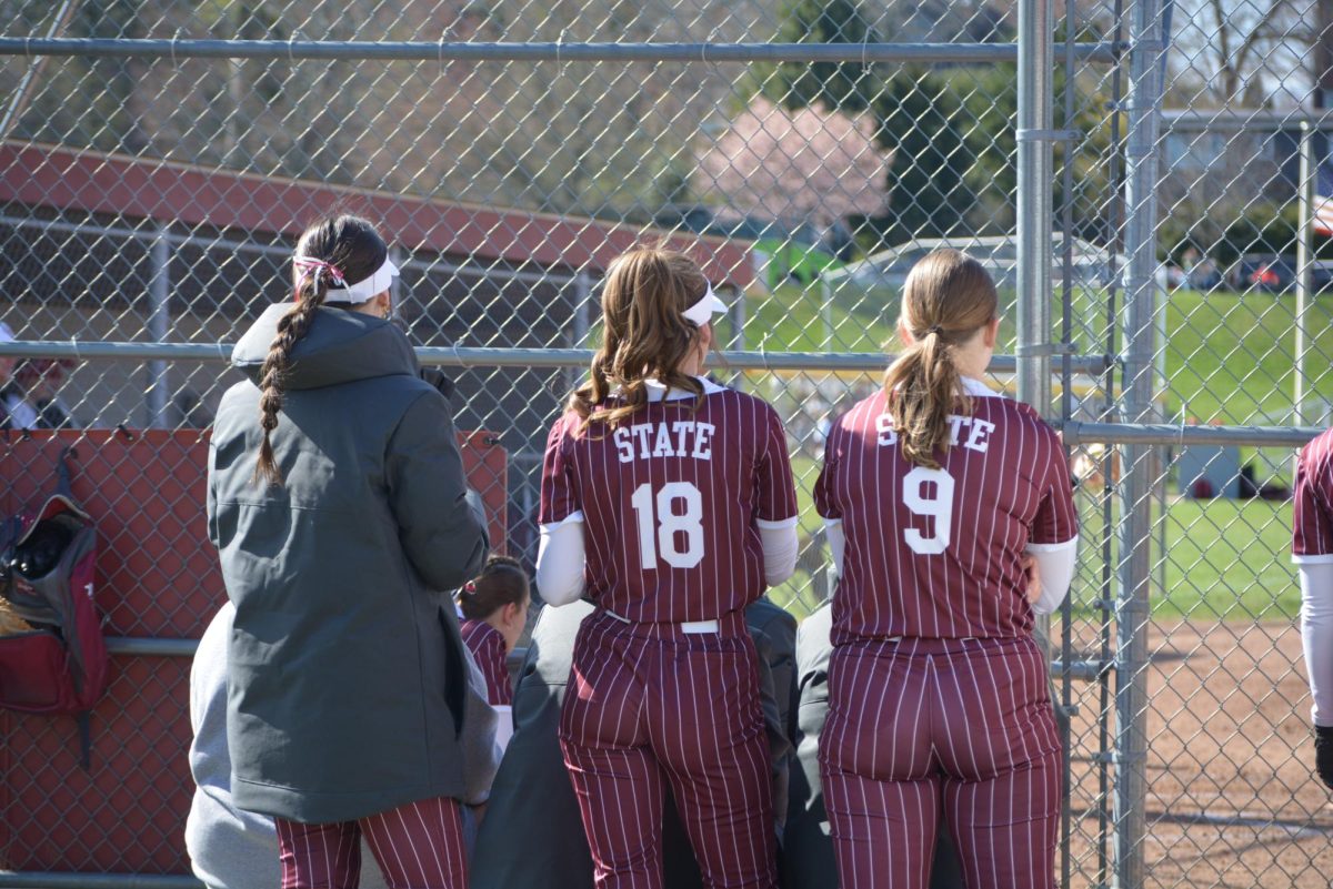 State High players watch the opposing team’s fielding. “Live in the moment because softball doesn’t last forever,” said junior Paige Moriarta.
