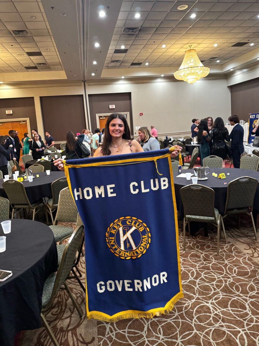 Heidi Egerer, Pennsylvania’s new Key Club Governor, holds a banner reading “Home Club Governor.” Photo courtesy of Fred Egerer. 