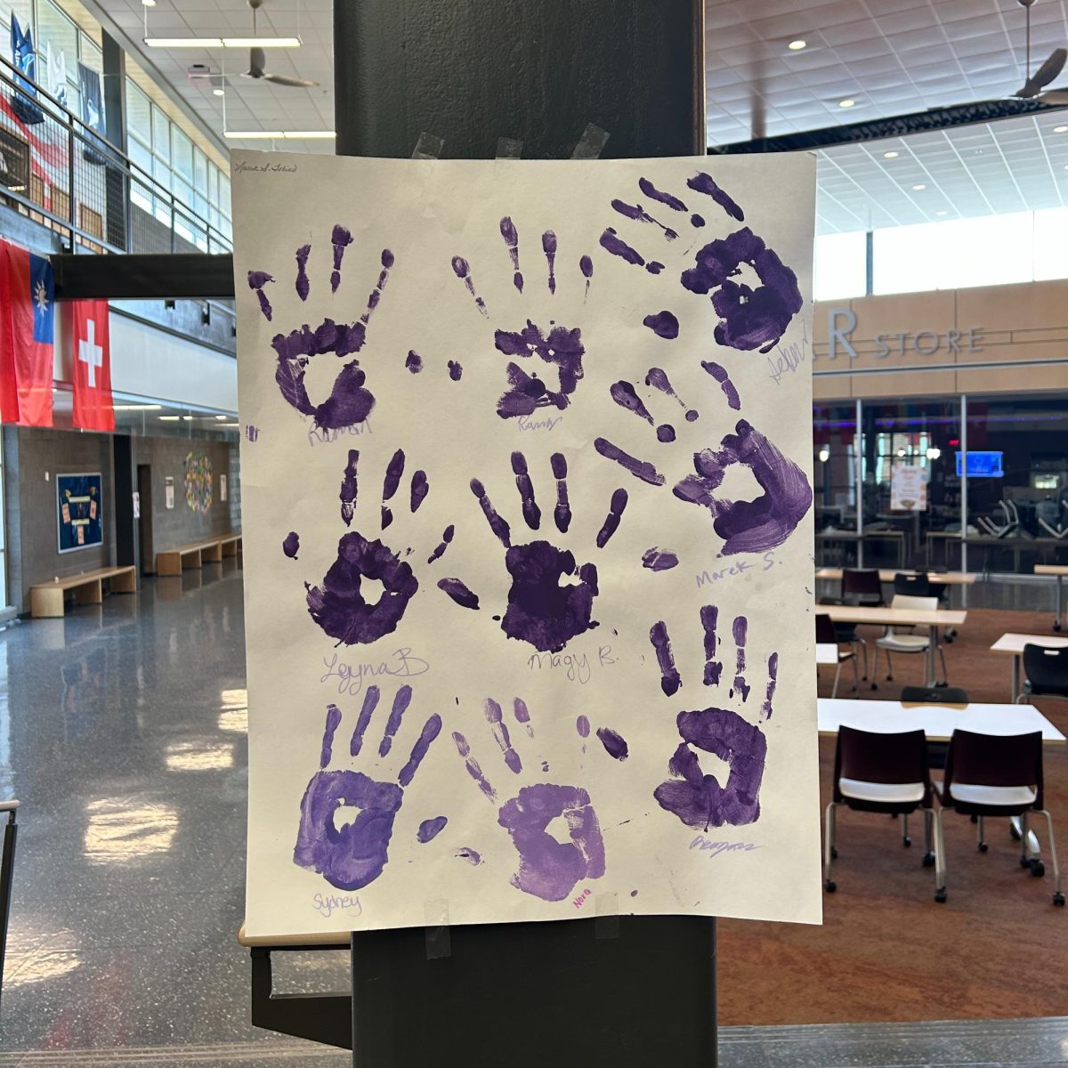 Purple Project poster with purple handprints in the hub.