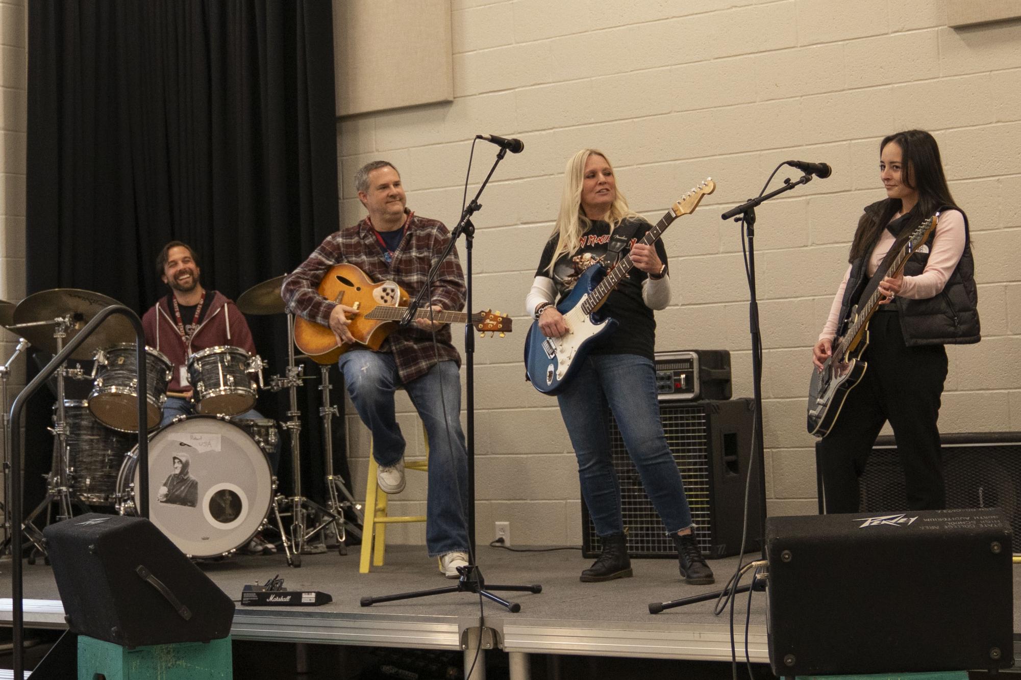State High's assistant principals, Brett Wilson, Ryan Walsh, Susan Hipp, and Danielle Ambrosia (L-R), celebrate Assistant Principals Week by performing for students in the rock ensemble class. 