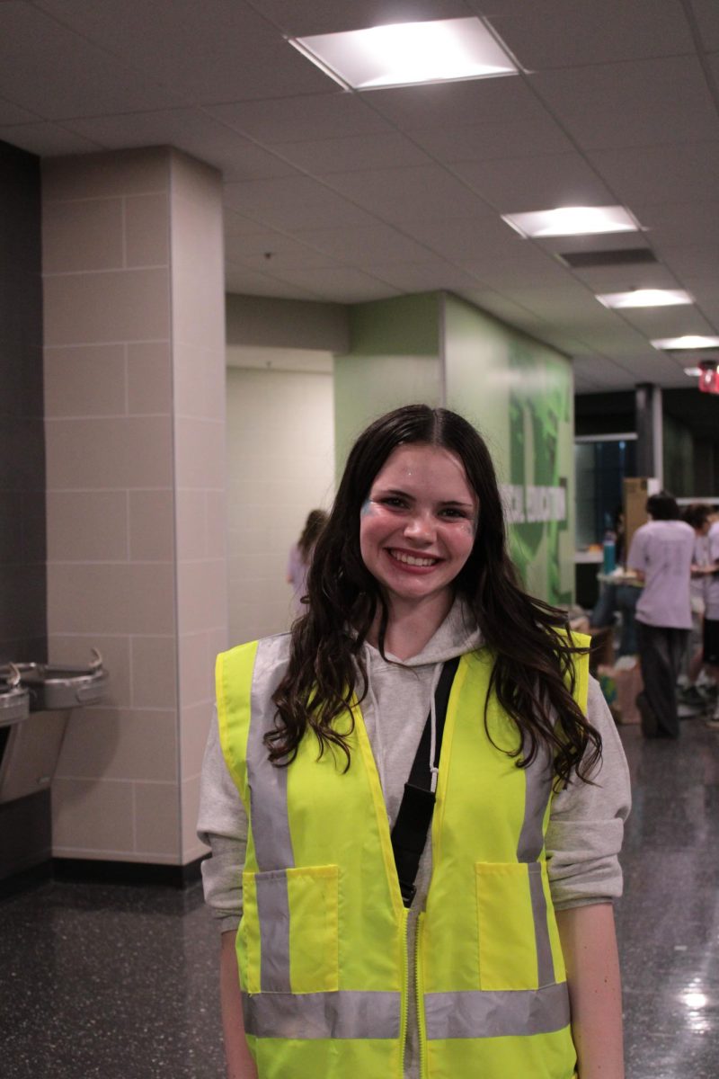 Alizza Fritz 11th Grade, wearing a neon vest. The bright yellow vests are worn by the club heads, Fritz acknowledged this. 