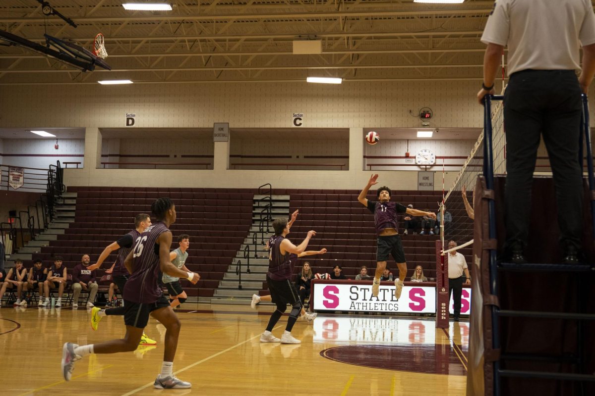 State High boys with a perfect setup for senior Deondre Sheffey to spike down.