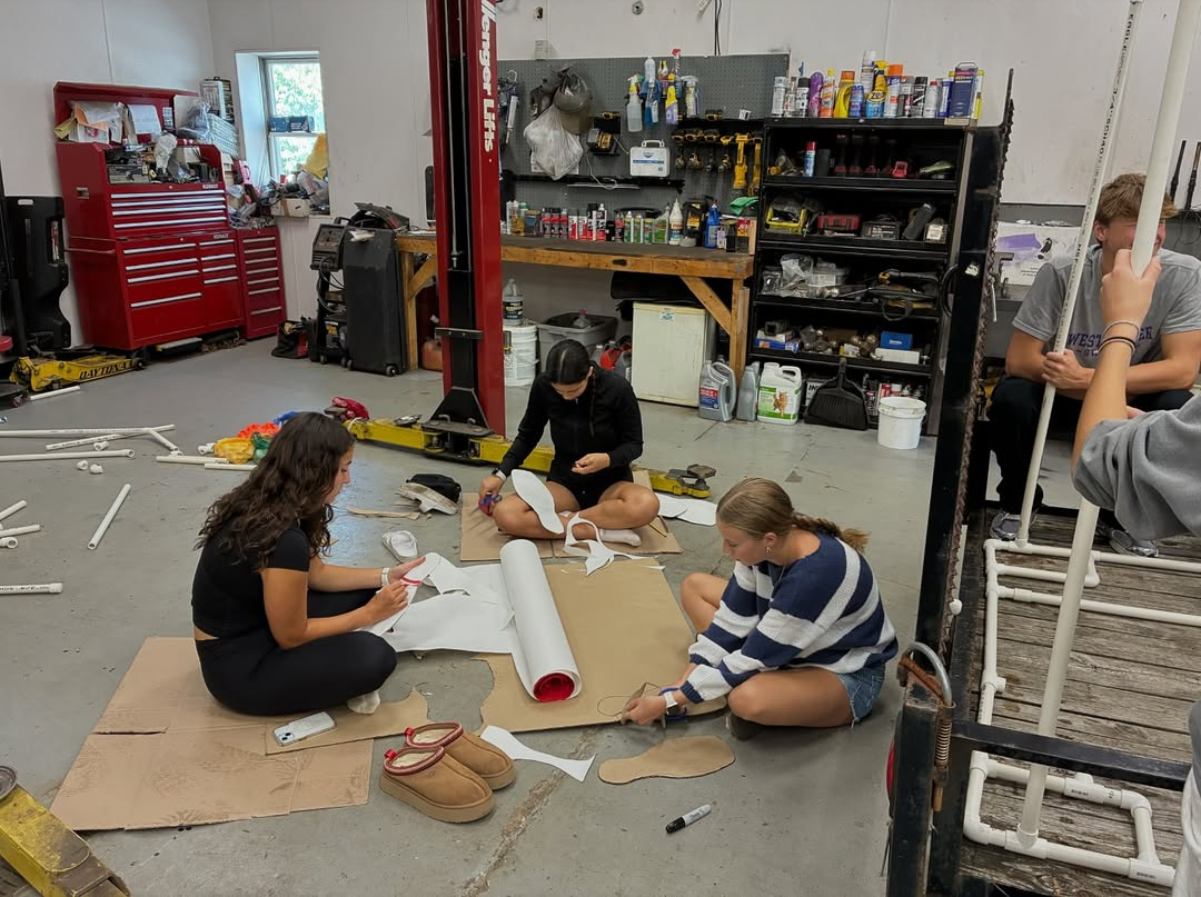 Swim team girls create decorations for their float. Photo courtesy of State High Swimming and Diving