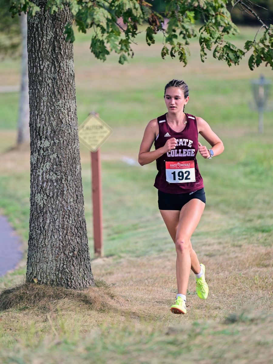 Sophomore Evie Younkin rounds a corner during her Tuesday race. Younkin finished the race solidly in first place, helping secure a whole team victory. "The thing that drives me when I run, especially during cross country, is my sense of community with my teammates and knowing that they are right with me, giving it their all every day, and that I also need to give it my all for them," Younkin said. 