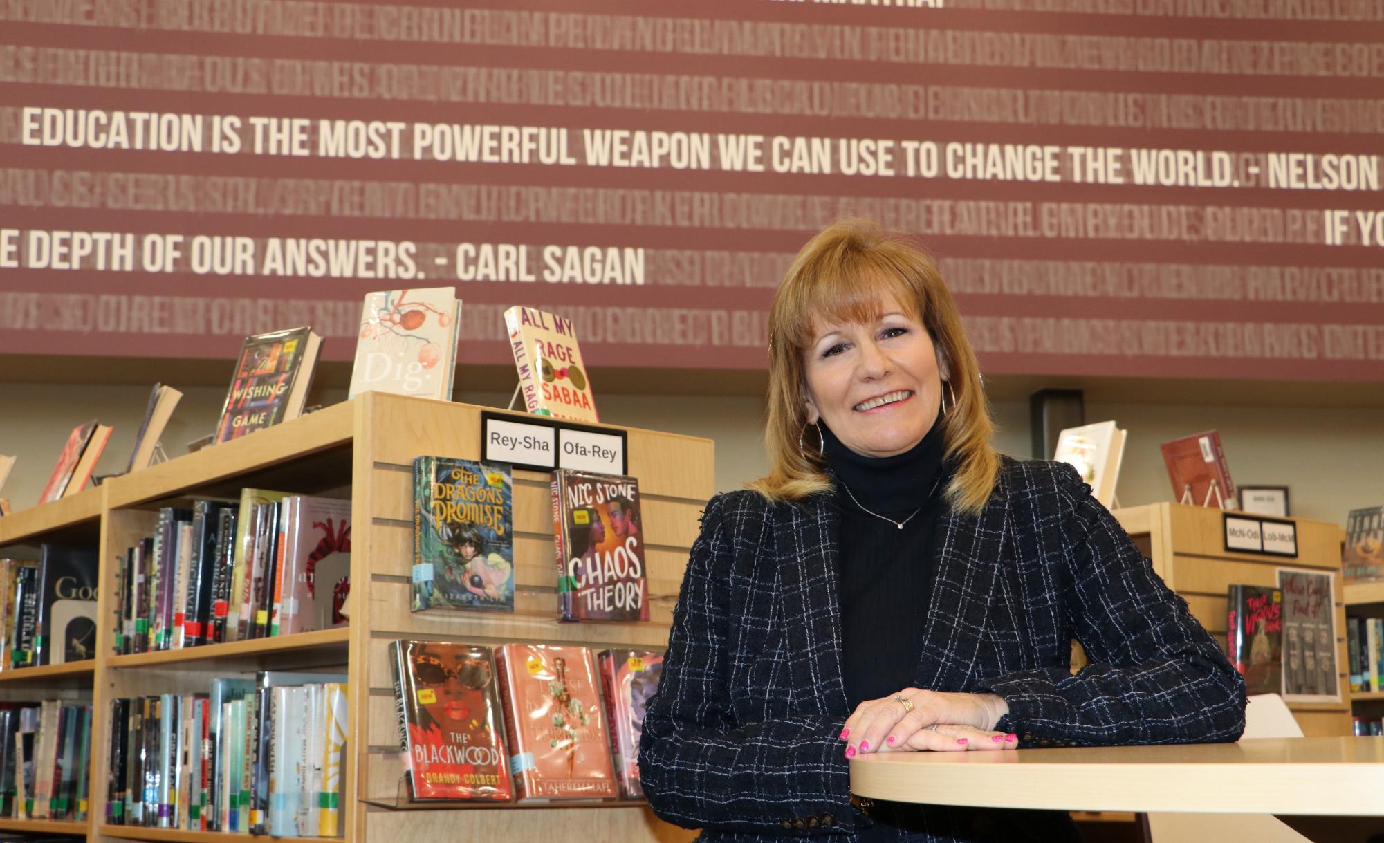 Dr. Cathi Fuhrman poses in the library. Photo courtesy of Nabil Mark