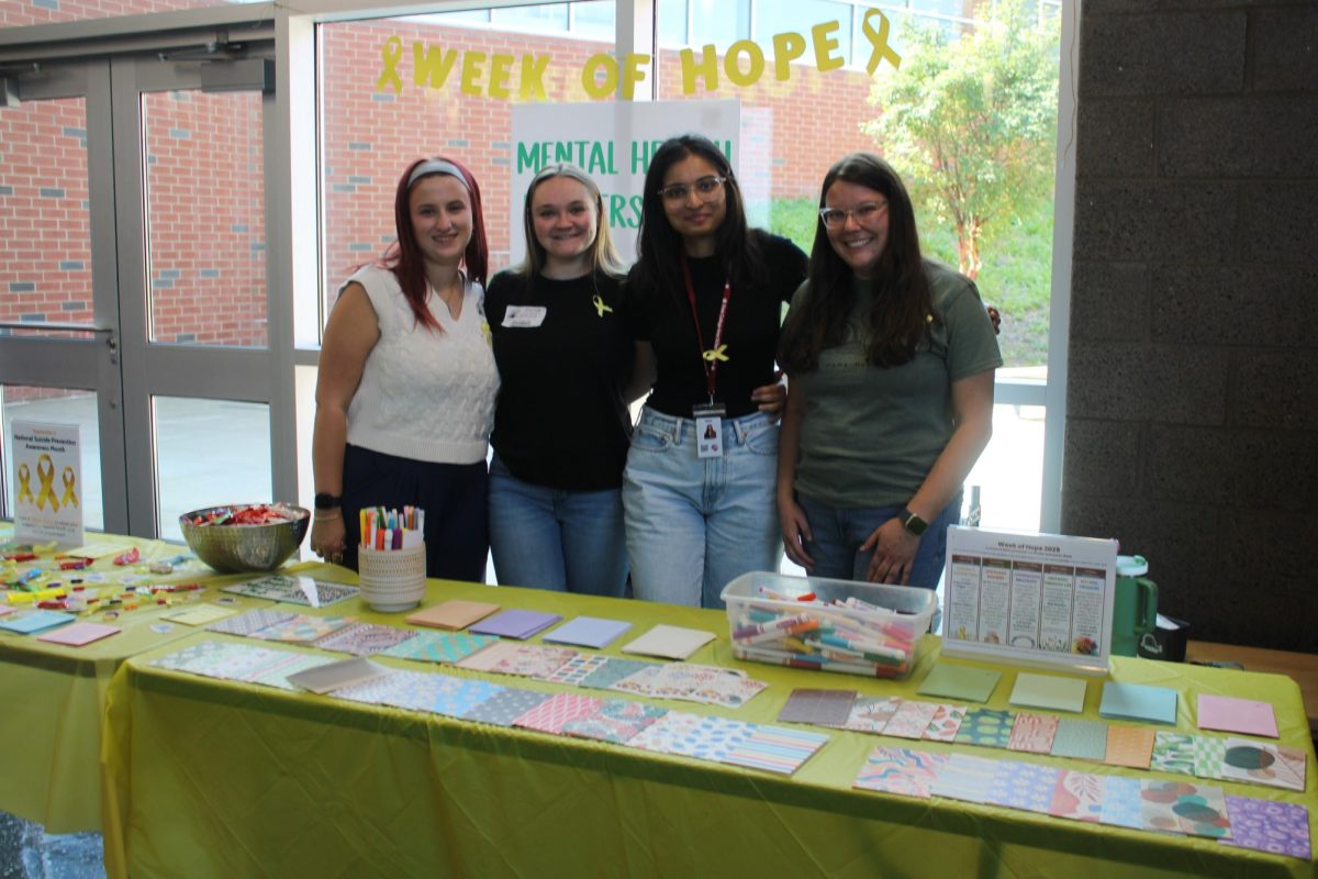 Member of mental health awareness group, the Jana Marie Foundation, Madison Border stands right of three students that are part of the school Mental Health Matters Club.