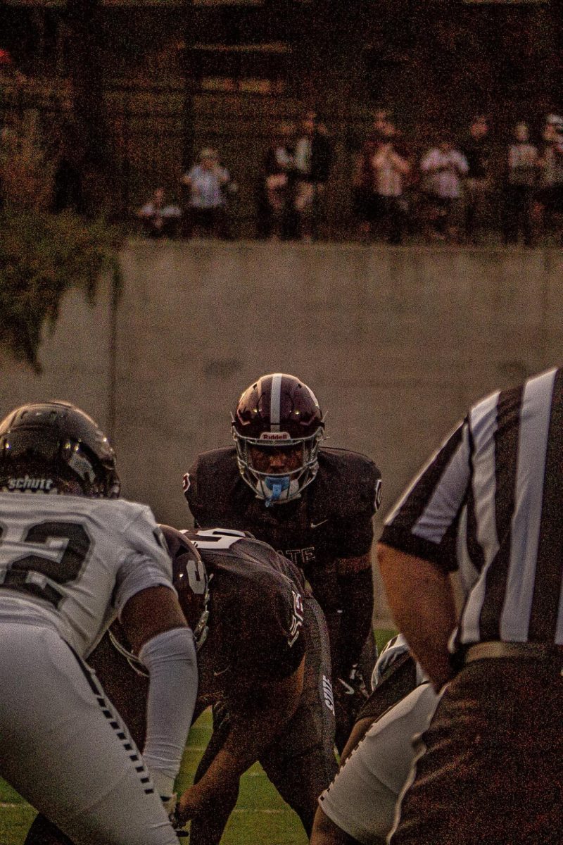 Senior running back D'Antae Sheffey locks eyes with the Harrisburg middle linebacker pre-snap. 