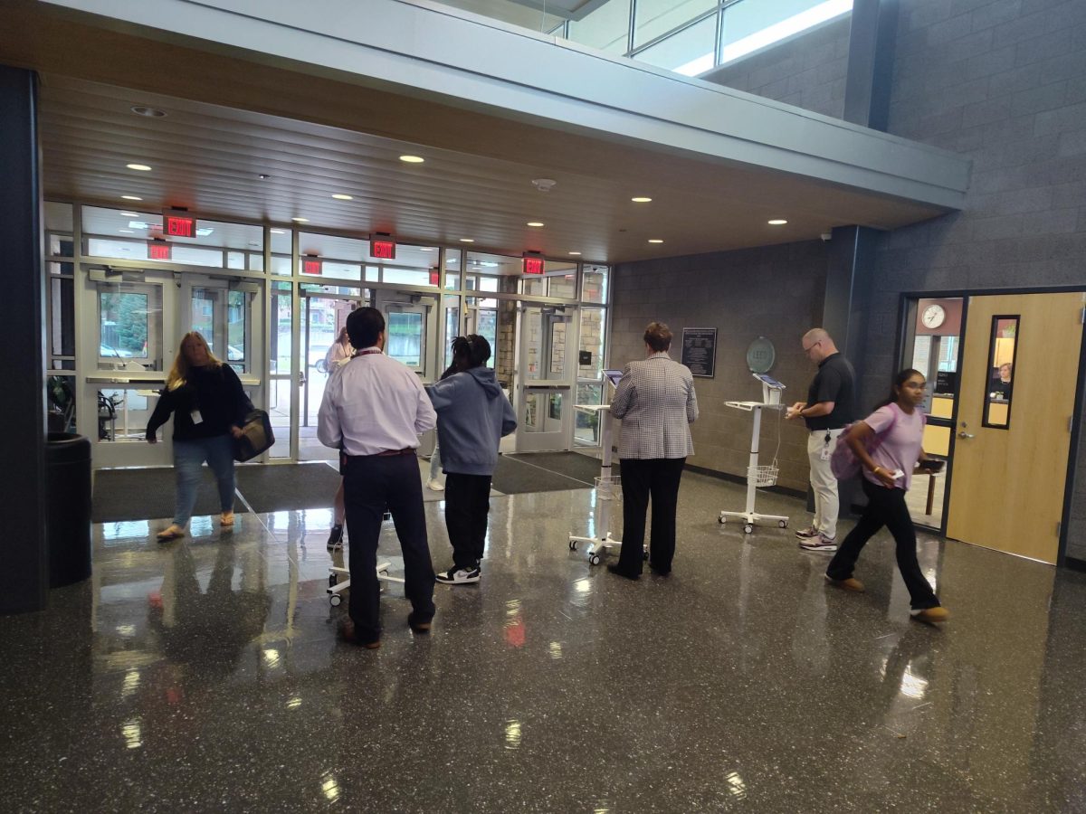 Students enter the back entrance through the new security procedures.