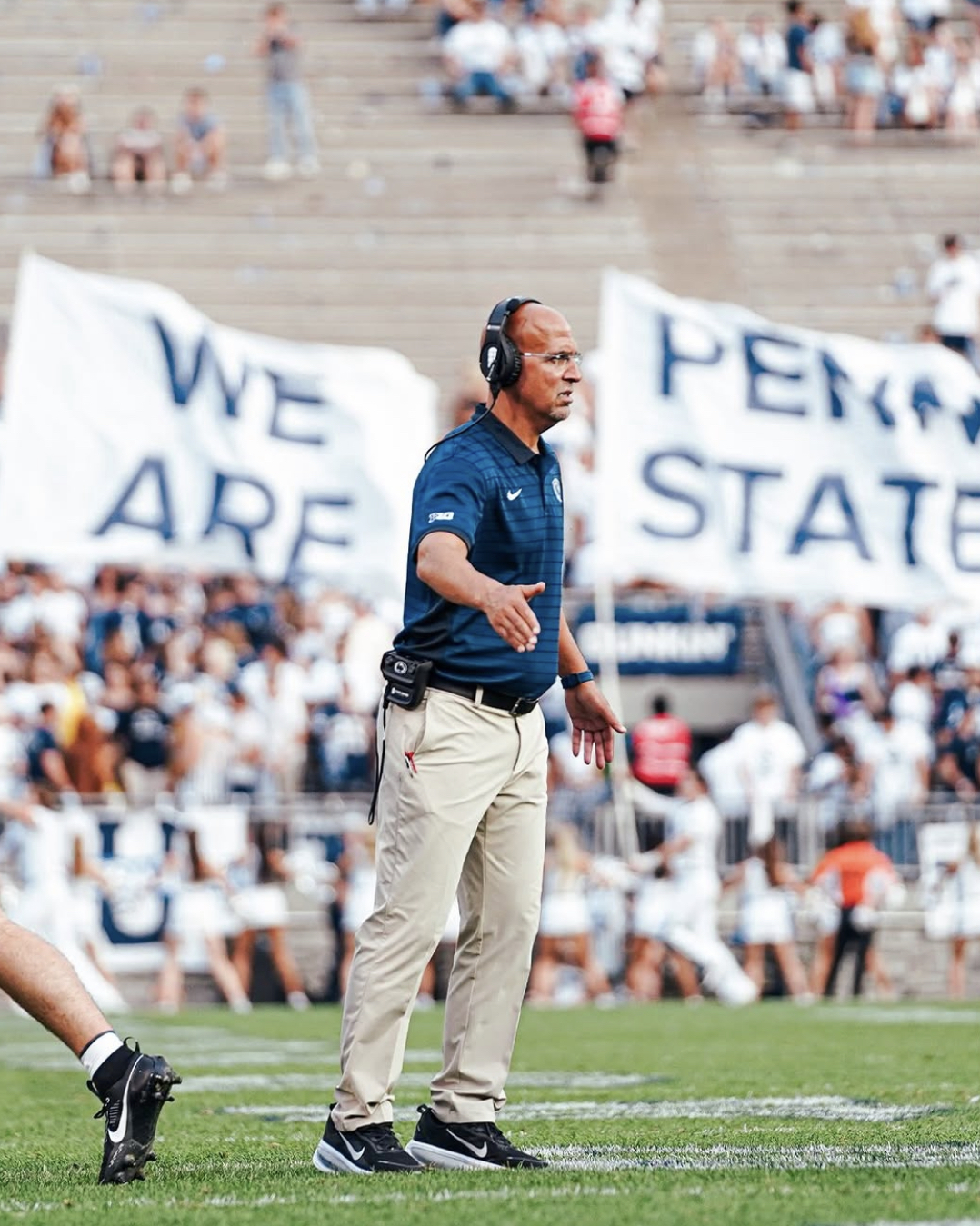 James Franklin, the Penn State Football head coach at the time, high-fives his players as they step off the field.
