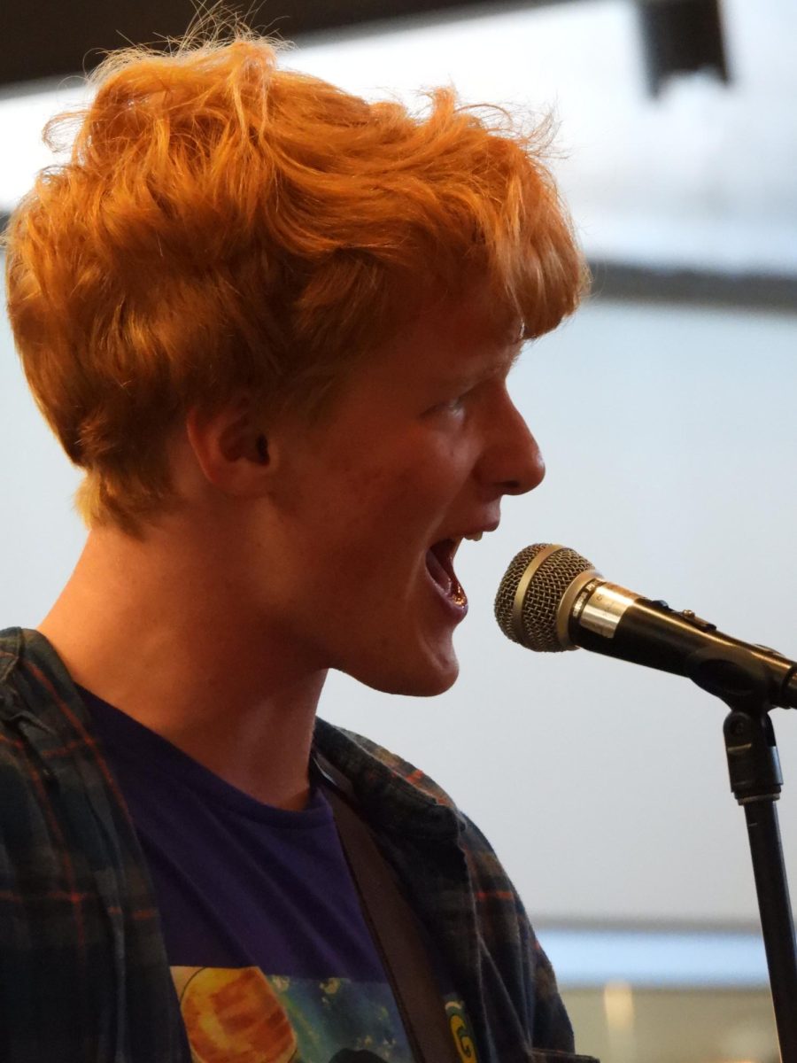 Senior Henry Mathews sings with his band, The Smash Tacklers, during fall fest. "It was really fun to get to do like the same songs 3 times in a row because we got to like, we just got better and better over the course of the event."