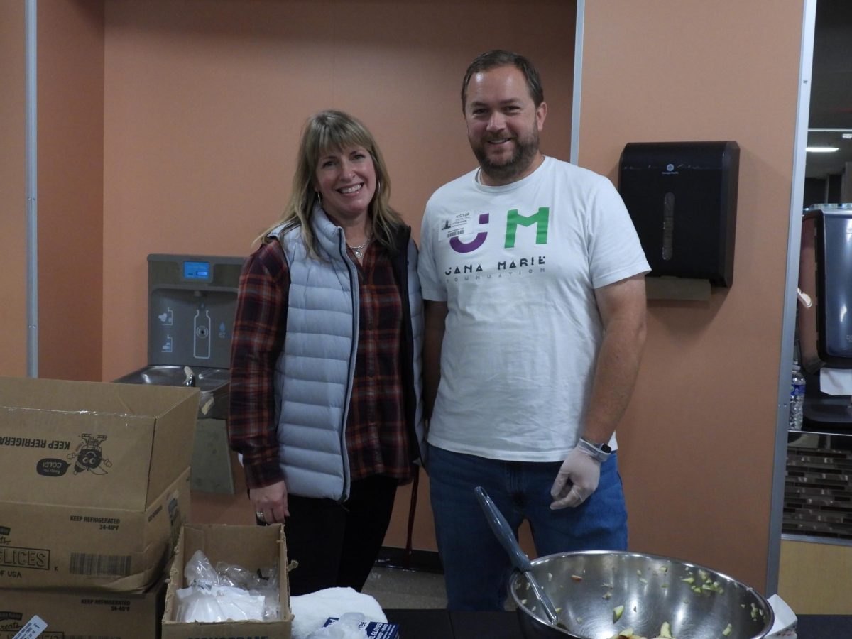 English teacher and PBIS Coordinator Jennifer Evans hands out apples with caramel and marshmallows with Peter Horn, a representative with the Jana Marie Foundation. "We are super excited to celebrate everyone here at the high school for all the good things they do on the daily basis. We have so many people who choose the right thing, who help others, who work really hard, and we want to make sure that everybody see you feel seen valued and heard" says Evans