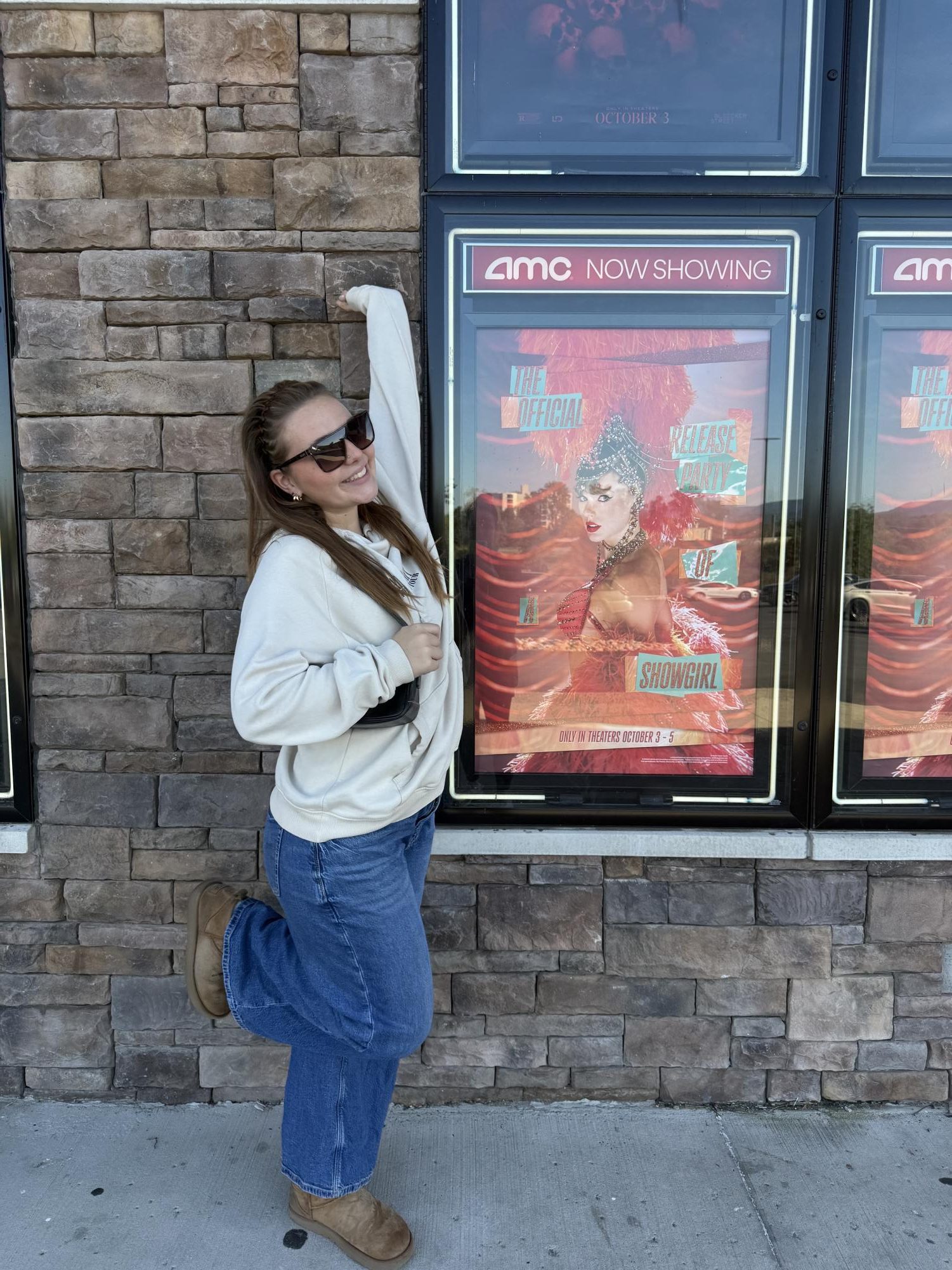 Senior Jackie Eveleth poses in front of poster for Taylor Swifts Official Release Party. Photo courtesy of Jackie Eveleth
