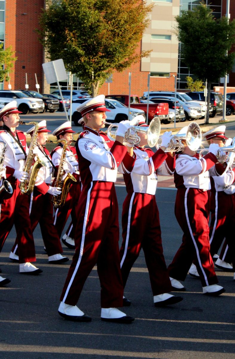 Junior Tyler Lippincott plays the trumpet as the marching band kicks off the parade with a tune. 