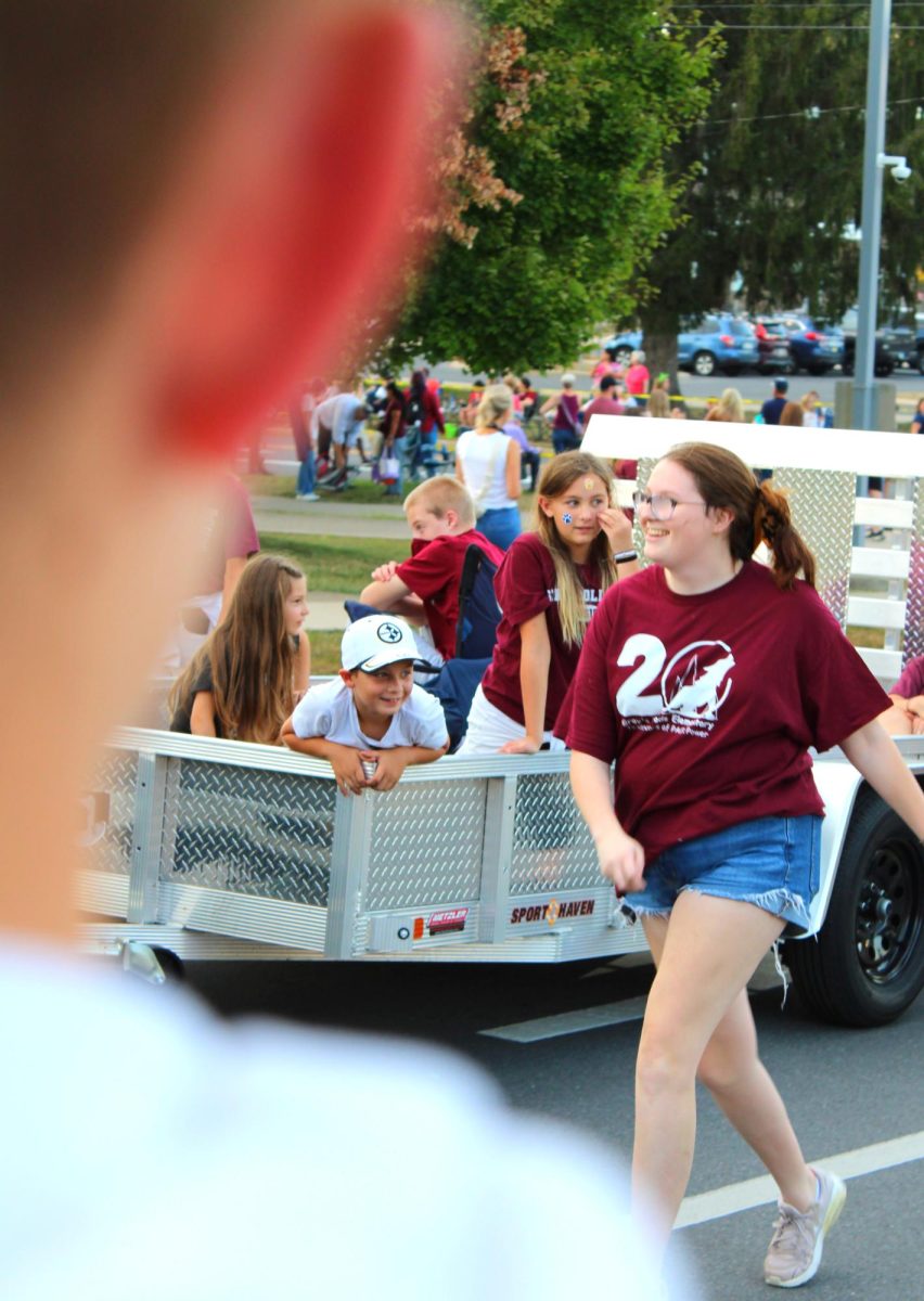 A Grays Woods Elementary school student leans out of a trailer as the parade enters its final stretch. The Homecoming Parade is always a highlight of the year for young students all over State College, and being a part of it is even more exciting for the little ones.
