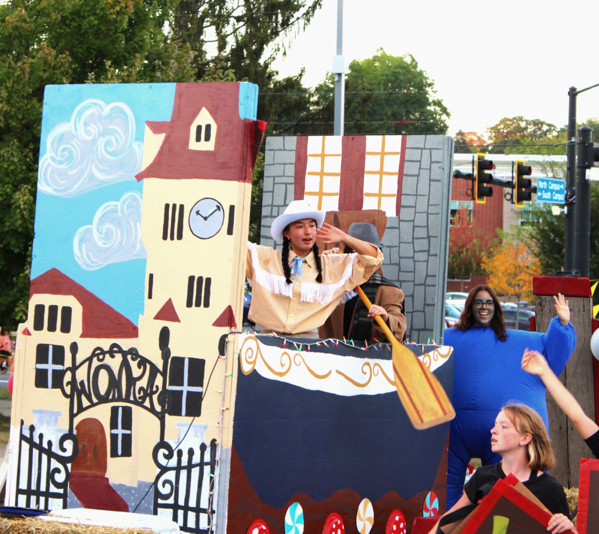 Senior Leila Crandall seeks energy from the parade crowd while atop the girls' soccer team’s Willy Wonka-themed float. Crandall, a captain for the second straight year, led the team to a 1-0 win over Mifflin County just two days after the parade, showing improvement from a two-win 2024-25 season.
