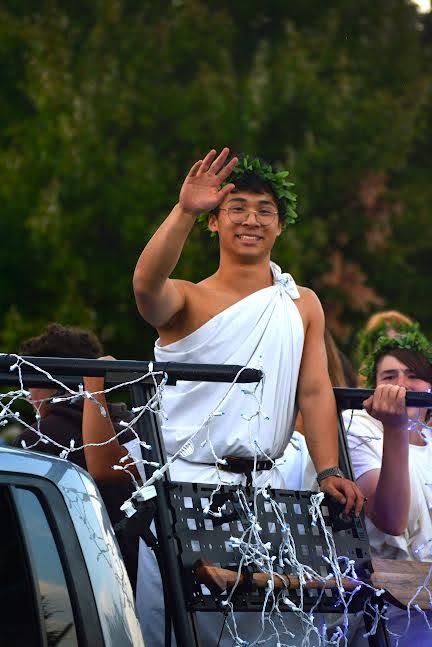 Senior Isaac Tan waves to the camera atop the rowing team’s float, on the opportunities being a senior within the parade presented. “It's nice to have a lot of student leadership and be able to create and produce the float…also the great leadership opportunities and express ourselves in our final year.”