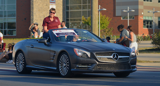 State High Principal Laura Tobias coasts down Westerly Parkway, waving to parade-goers.
